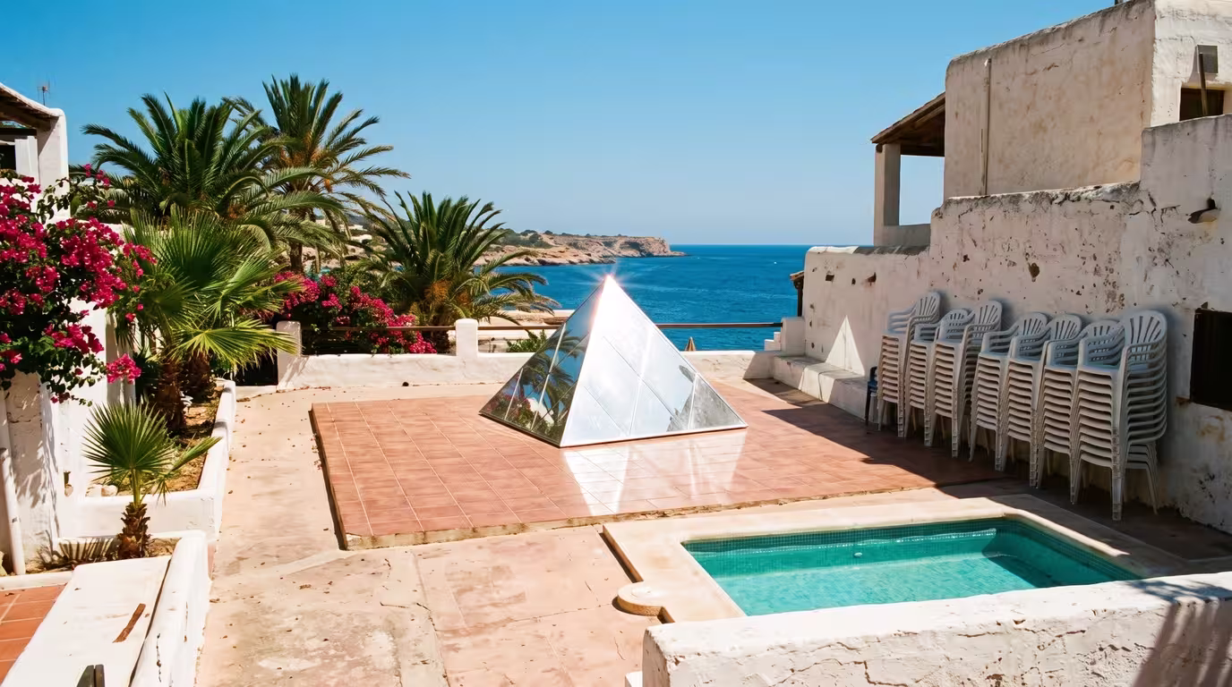 Whitewashed open-air Ibiza club terrace with palms and a pool in the late 1980s